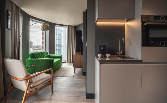 living room with a green chair in the foreground