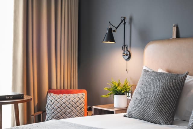 shot of a bedroom with a bed and a chair