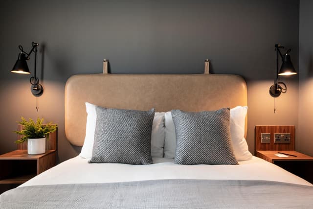 bedroom with a bed and two lamps on either side of the bed