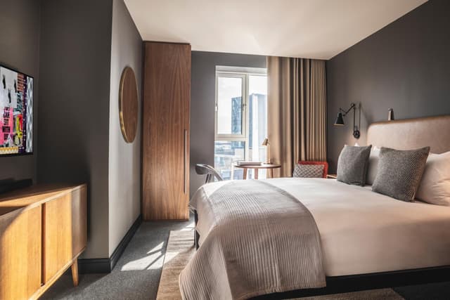 bedroom with a large bed and a flat screen tv