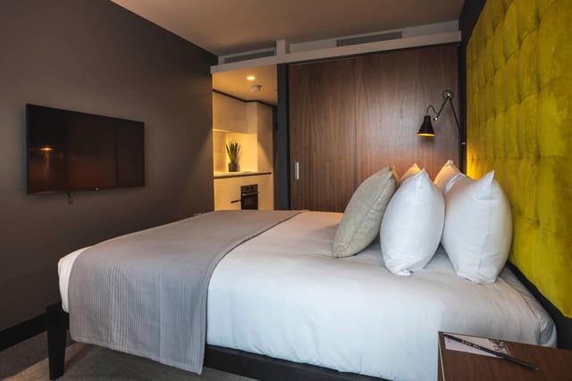 bedroom with a large bed and a flat screen tv