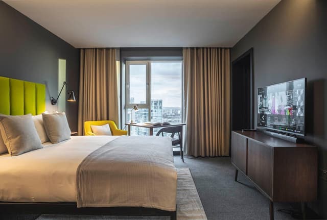 hotel room with a large bed and a flat screen tv