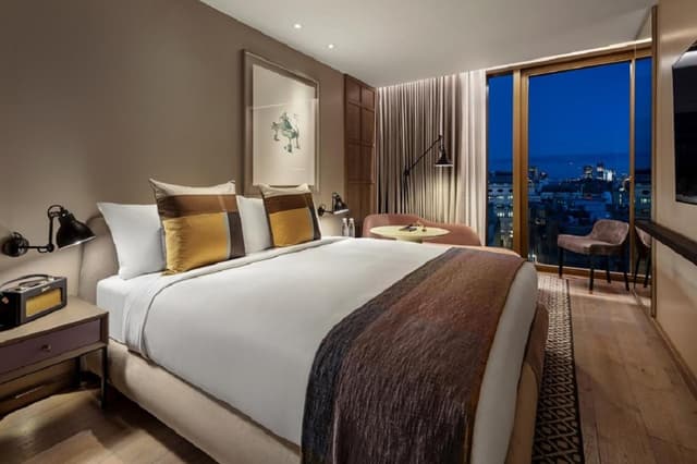 hotel room with a view of the city at night