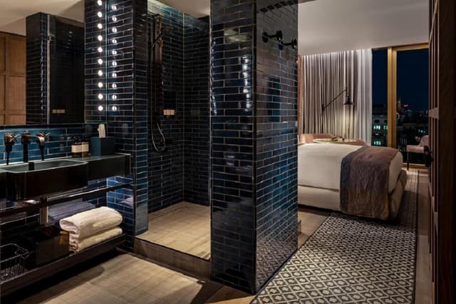 bathroom with a walk in shower and a double sink