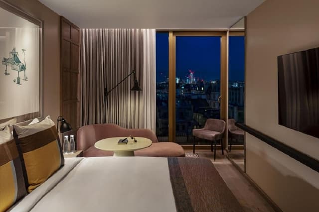 hotel room with a view of the city at night