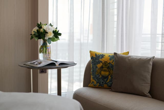 living room with a couch, coffee table and vase of flowers