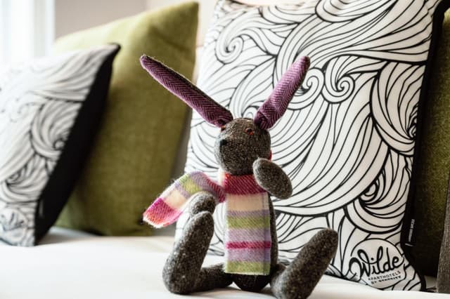close up of a stuffed rabbit sitting on a couch