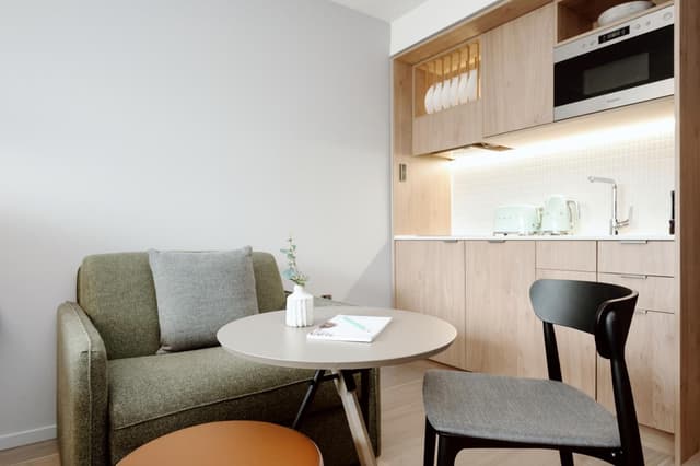 small living room with a kitchen in the back ground