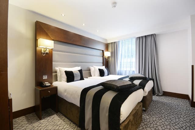 hotel room with black and white striped bedspread