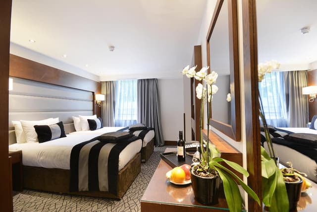 hotel room with two double beds and a large mirror