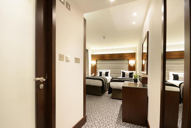 hotel room with two beds and a desk in it