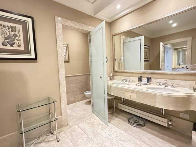 bathroom with two sinks and a large mirror on the wall