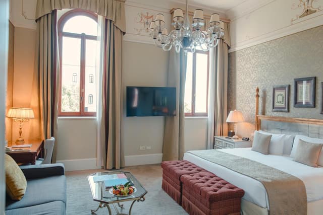 hotel room with a king size bed and chandelier