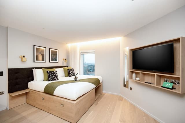 bedroom with a large bed and a flat screen tv