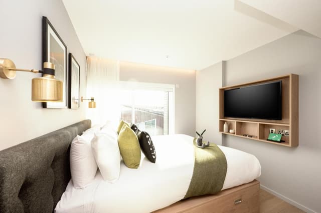 bedroom with a large bed and a flat screen tv
