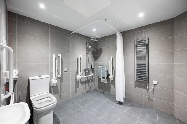 Relax in our modern, spacious bathroom retreat.