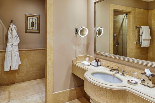 bathroom with a sink, shower, and bathrobe