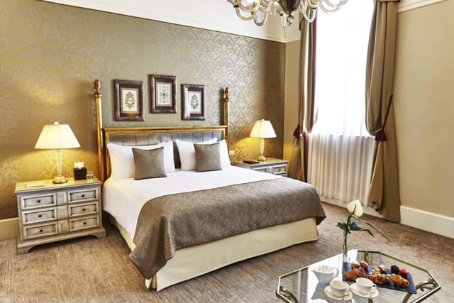 hotel room with a bed and a chandelier