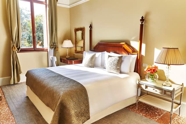 hotel room with a king size bed and large windows