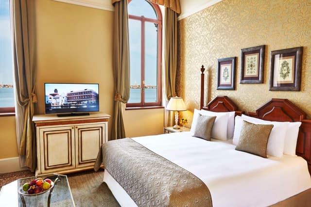hotel room with a large bed and a flat screen tv