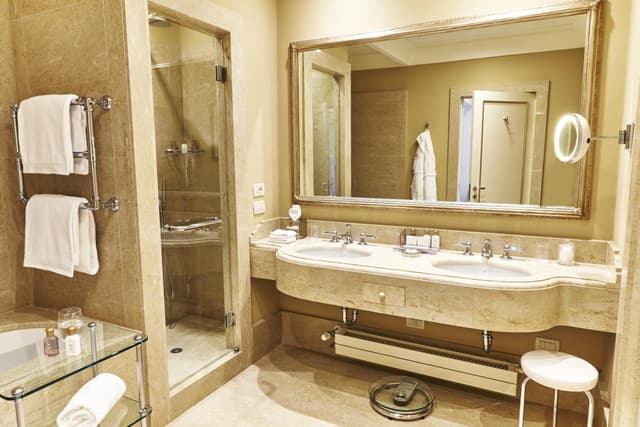 bathroom with a bathtub, shower, and sink