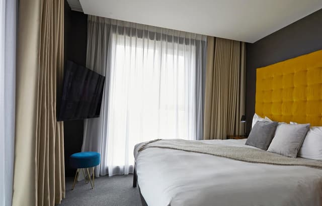 hotel room with a large bed and a flat screen tv