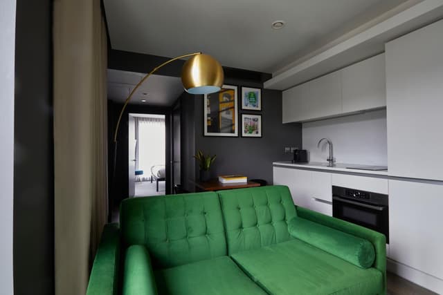 green couch in the living room of a modern apartment