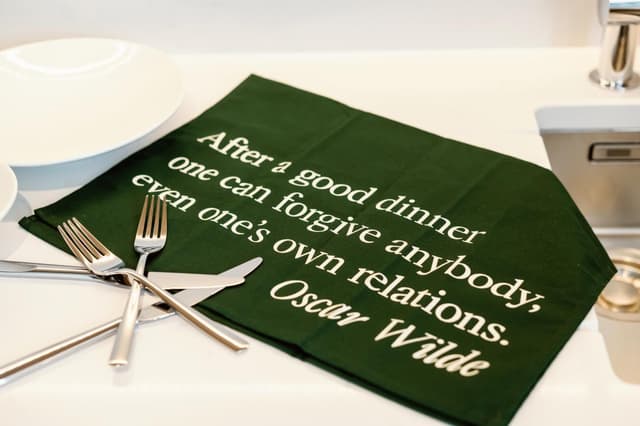 green napkin with the words, after a good dinner one can forgive anybody even one's own nations