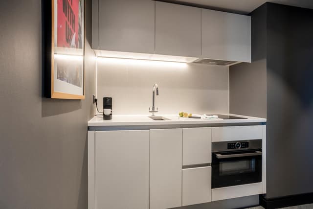kitchen with an oven, sink, and coffee maker